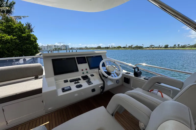 Slide: The Image of Flybridge helm of 2018 Azimut 66 yacht with scenic waterfront view. - 18