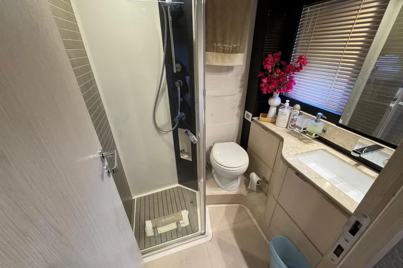 Slide: The Image of Luxurious bathroom in 2018 Azimut 66 Flybridge yacht with shower, sink, and elegant decor. - 40