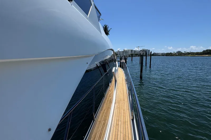 Slide: The Image of 2018 Azimut 66 Flybridge yacht docked by the water on a sunny day. - 10
