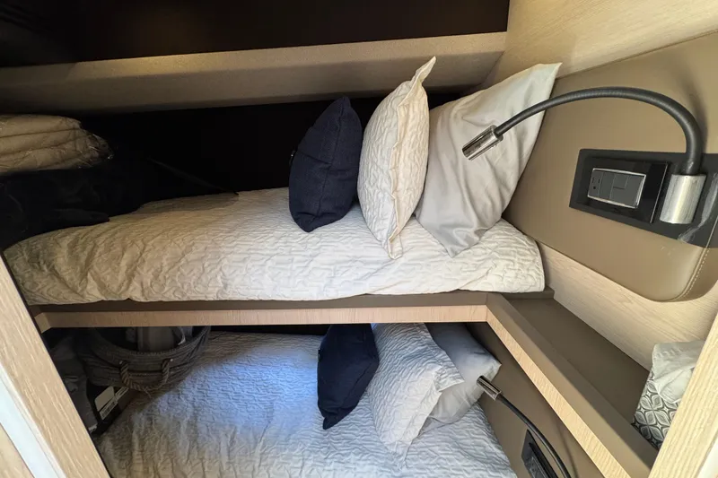 Slide: The Image of Bunk beds in 2018 Azimut 66 Flybridge yacht cabin with reading lights and pillows. - 44