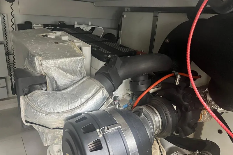 Slide: The Image of Engine compartment of a 2018 Azimut 66 yacht, showcasing mechanical components and wiring. - 54