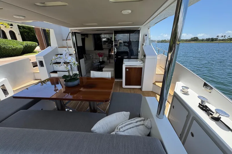 Slide: The Image of Luxurious 2018 Azimut 66 Flybridge yacht with elegant outdoor seating and scenic water view. - 12