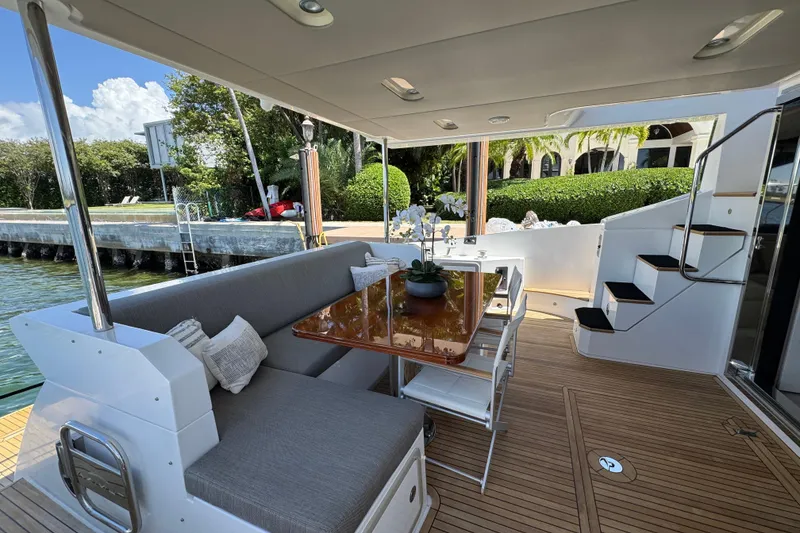 Slide: The Image of Luxurious 2018 Azimut 66 Flybridge yacht deck with elegant seating and dining area. - 13