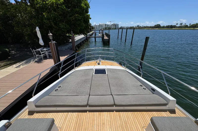 Slide: The Image of 2018 Azimut 66 Flybridge yacht docked by a scenic waterfront. - 5