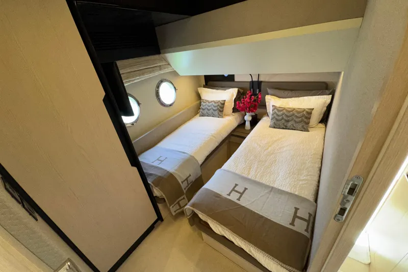 Slide: The Image of Luxurious twin cabin in 2018 Azimut 66 Flybridge yacht, featuring elegant bedding and decor. - 43