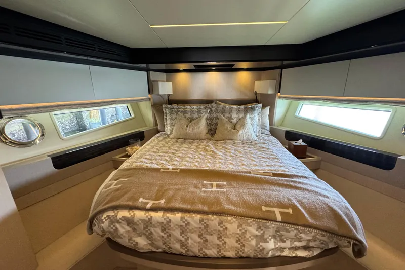 Slide: The Image of Luxurious bedroom interior of 2018 Azimut 66 Flybridge yacht with elegant bedding and windows. - 37