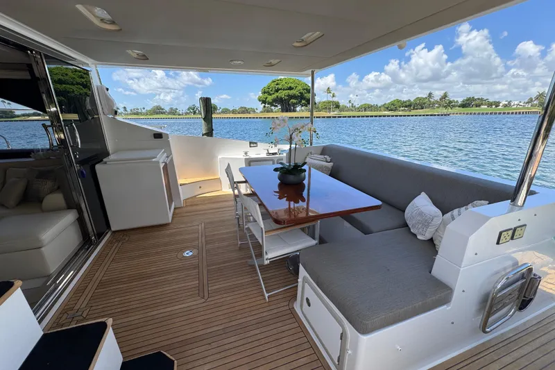 Slide: The Image of Luxurious 2018 Azimut 66 Flybridge yacht with elegant outdoor seating and scenic water view. - 14