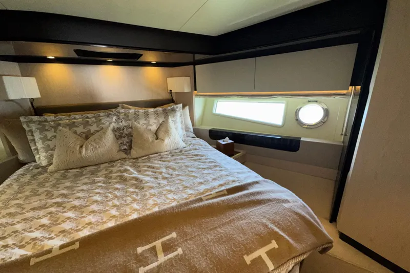 Slide: The Image of Luxurious bedroom interior of 2018 Azimut 66 Flybridge yacht with elegant bedding and porthole window. - 39