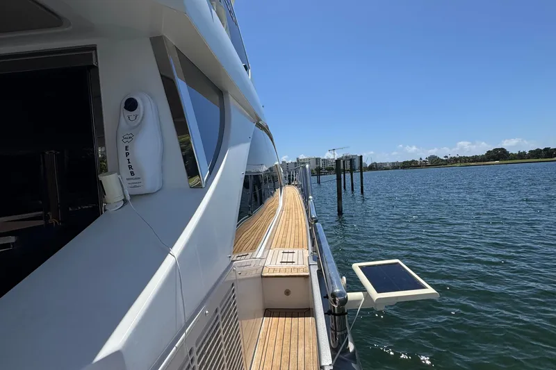Slide: The Image of 2018 Azimut 66 Flybridge yacht on calm water, sunny day, side view. - 11