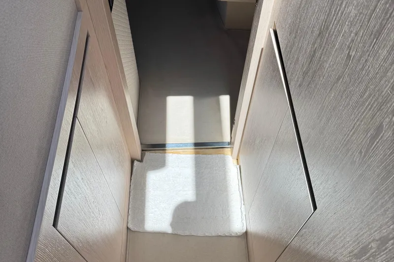 Slide: The Image of Interior hallway of 2018 Azimut 66 Flybridge yacht with light wood paneling. - 45