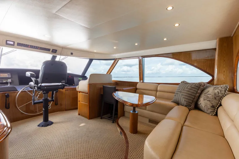 Slide: The Image of Luxurious interior of 2012 Viking 76 Enclosed Bridge yacht with plush seating and helm station. - 55