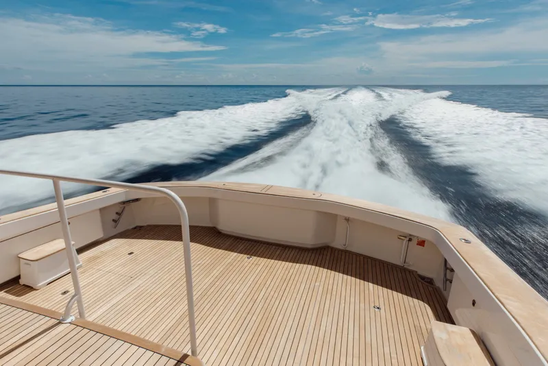 Slide: The Image of Sleek 2012 Viking 76 Enclosed Bridge yacht cruising on open ocean waters. - 24