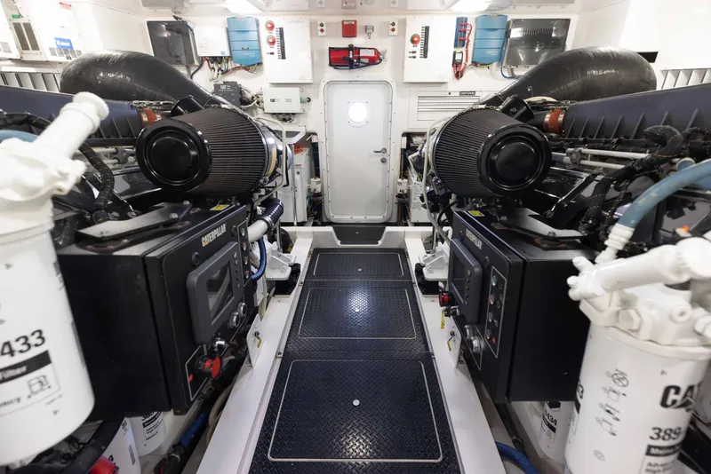 Slide: The Image of Engine room of 2012 Viking 76 Enclosed Bridge yacht, featuring Caterpillar engines and control systems. - 107