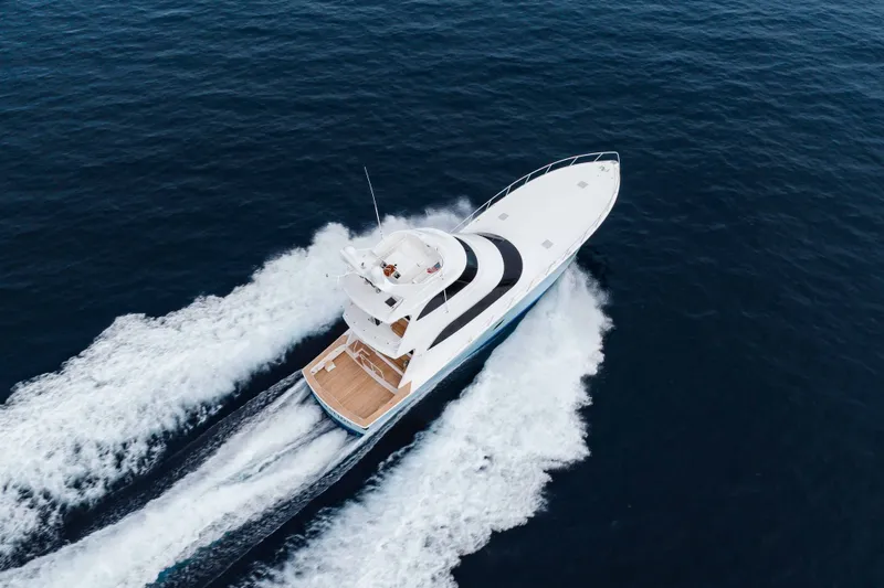 Slide: The Image of Aerial view of 2012 Viking 76 Enclosed Bridge yacht cruising on open sea. - 18