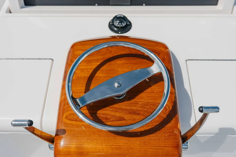 Slide: The Image of Steering wheel of 2012 Viking 76 Enclosed Bridge yacht with wooden finish. - 51
