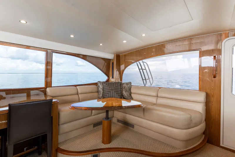 Slide: The Image of Luxurious interior of 2012 Viking 76 Enclosed Bridge yacht with plush seating and ocean view. - 54