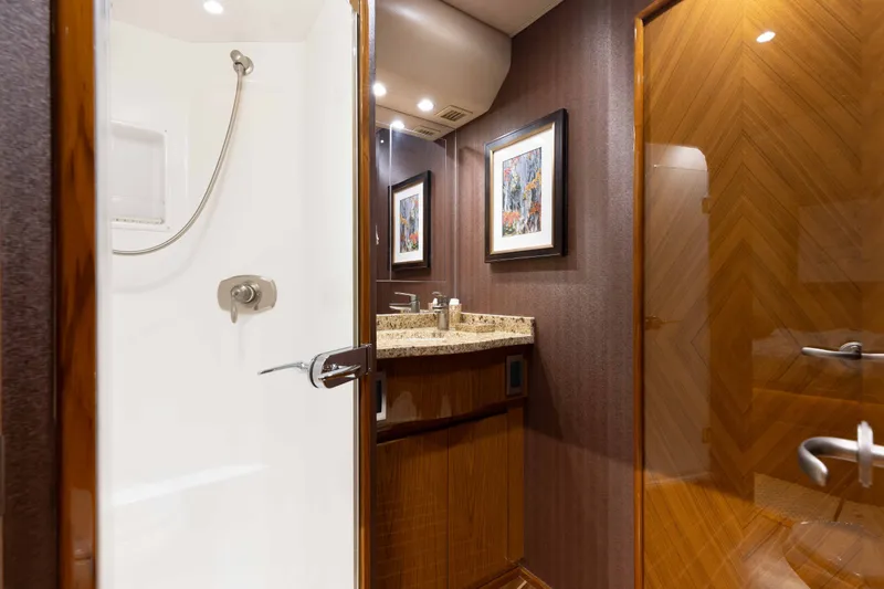 Slide: The Image of Luxurious bathroom interior of 2012 Viking 76 Enclosed Bridge yacht with shower and granite countertop. - 91