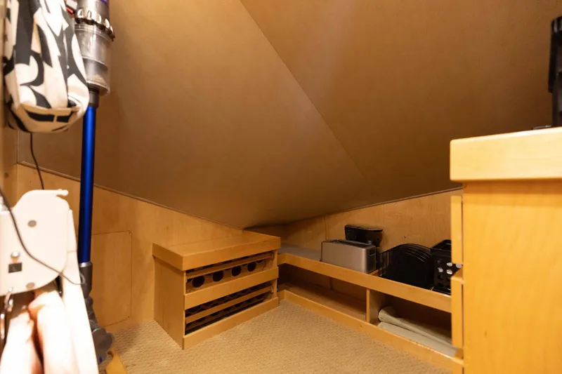 Slide: The Image of Storage area in 2012 Viking 76 Enclosed Bridge yacht with vacuum and shelving. - 103