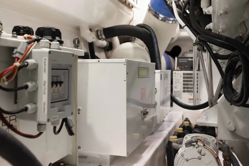 Slide: The Image of Engine room of 2012 Viking 76 Enclosed Bridge yacht, showcasing electrical systems and components. - 113