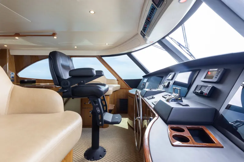 Slide: The Image of Luxurious interior of 2012 Viking 76 Enclosed Bridge yacht helm station. - 60