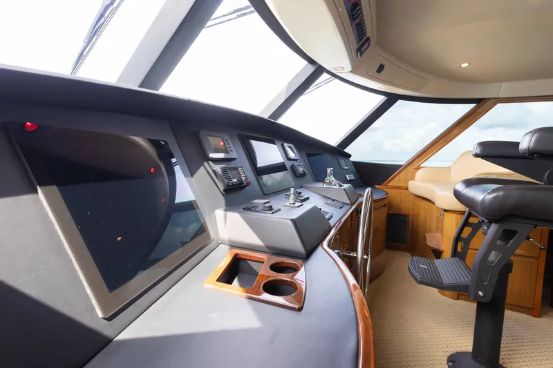 Slide: The Image of Luxurious interior of 2012 Viking 76 Enclosed Bridge yacht with modern navigation equipment. - 58