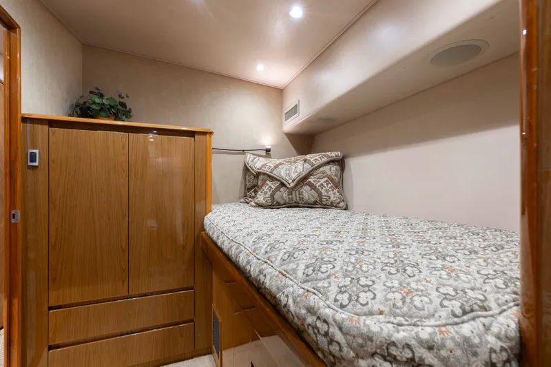 Slide: The Image of Cozy cabin interior of 2012 Viking 76 Enclosed Bridge yacht with patterned bedding. - 95