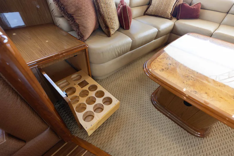 Slide: The Image of Luxurious interior of 2012 Viking 76 Enclosed Bridge yacht with elegant seating and wooden table. - 67