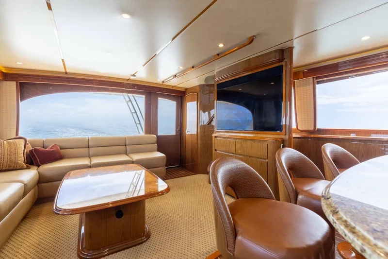 Slide: The Image of Luxurious interior of 2012 Viking 76 Enclosed Bridge yacht with plush seating and ocean view. - 69