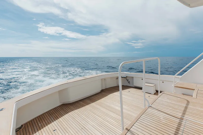 Slide: The Image of Deck view of 2012 Viking 76 Enclosed Bridge yacht cruising on open sea. - 28