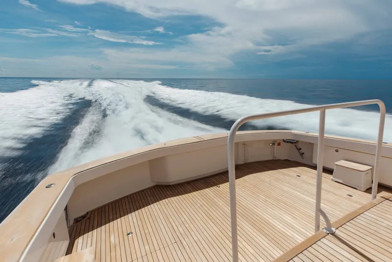 Slide: The Image of Sleek 2012 Viking 76 Enclosed Bridge yacht cruising on open ocean, leaving a foamy wake. - 26