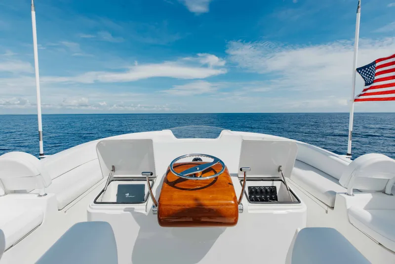 Slide: The Image of 2012 Viking 76 Enclosed Bridge yacht helm with ocean view and American flag. - 44