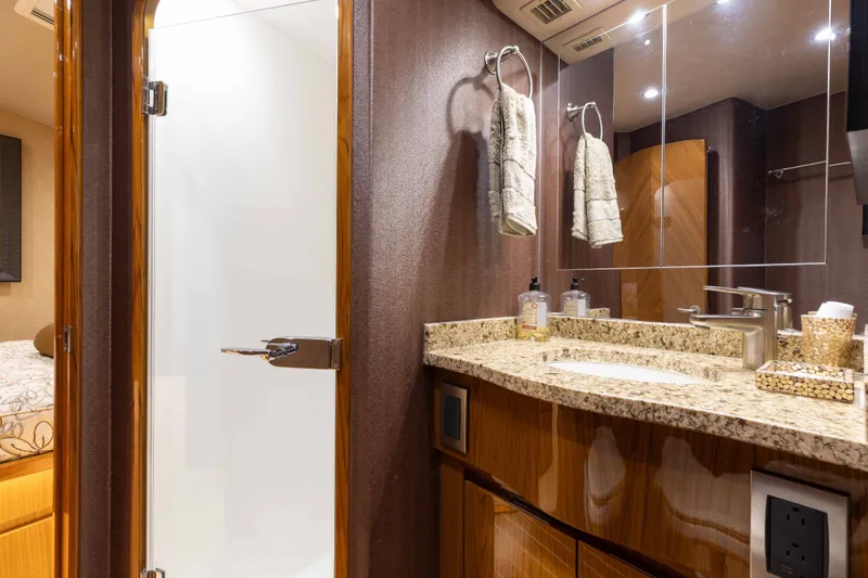 Slide: The Image of Luxurious bathroom interior of 2012 Viking 76 Enclosed Bridge yacht with granite countertop. - 90