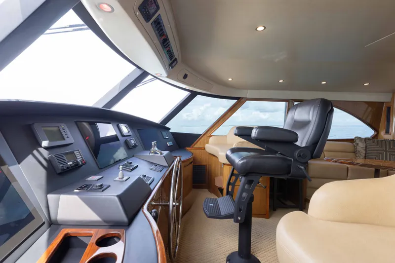 Slide: The Image of Luxurious interior of 2012 Viking 76 Enclosed Bridge yacht with modern helm and seating. - 57