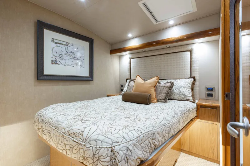 Slide: The Image of Luxurious bedroom interior on 2012 Viking 76 Enclosed Bridge yacht, featuring elegant bedding and decor. - 88