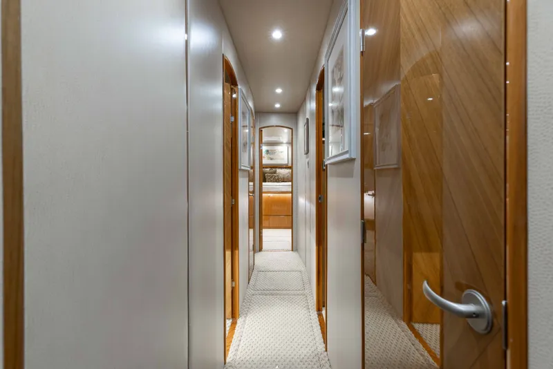 Slide: The Image of Hallway inside 2012 Viking 76 Enclosed Bridge yacht, featuring elegant wood finishes. - 82