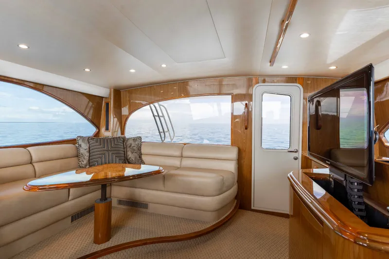 Slide: The Image of Luxurious interior of 2012 Viking 76 Enclosed Bridge yacht with plush seating and ocean view. - 53