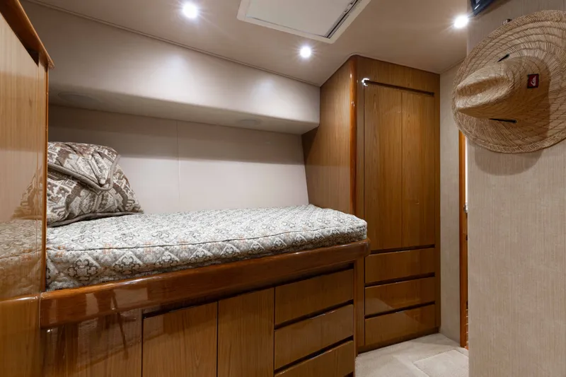 Slide: The Image of Luxurious cabin interior of 2012 Viking 76 Enclosed Bridge yacht with cozy bedding. - 94