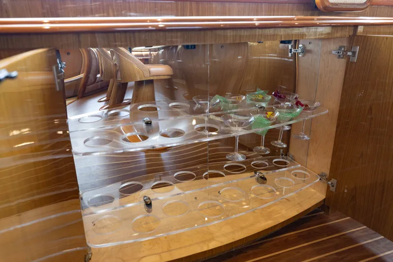 Slide: The Image of Luxurious wooden cabinet with glassware on a 2012 Viking 76 Enclosed Bridge yacht. - 78