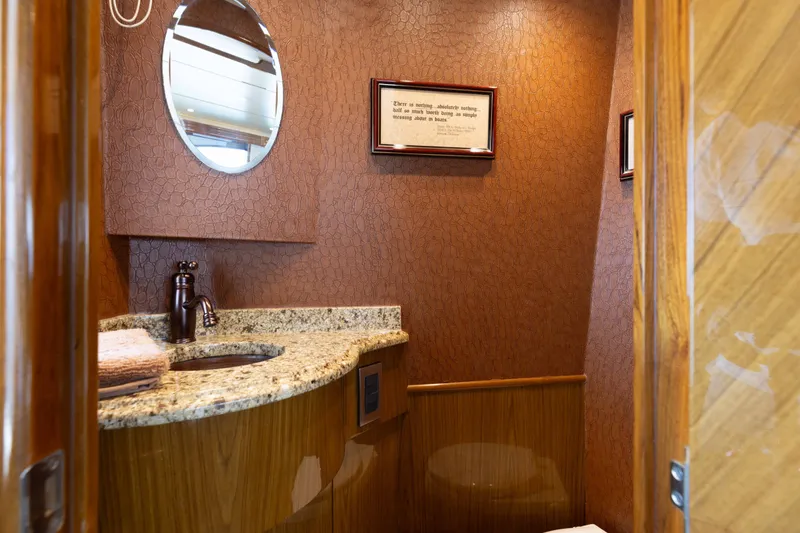 Slide: The Image of Luxurious bathroom interior on 2012 Viking 76 Enclosed Bridge yacht with granite countertop. - 63