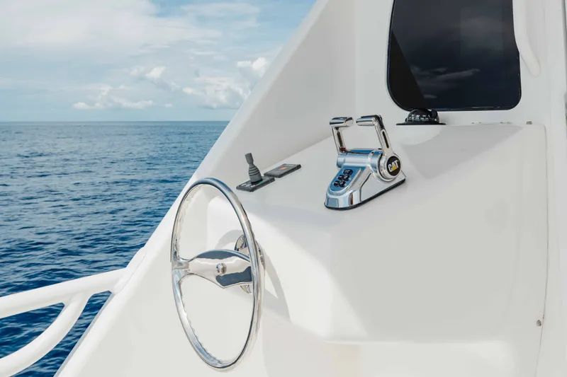 Slide: The Image of Steering wheel and controls on 2012 Viking 76 Enclosed Bridge yacht, ocean view. - 37