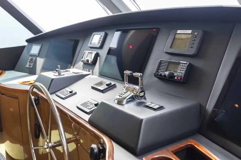 Slide: The Image of Control panel of a 2012 Viking 76 Enclosed Bridge yacht, featuring advanced navigation equipment. - 61