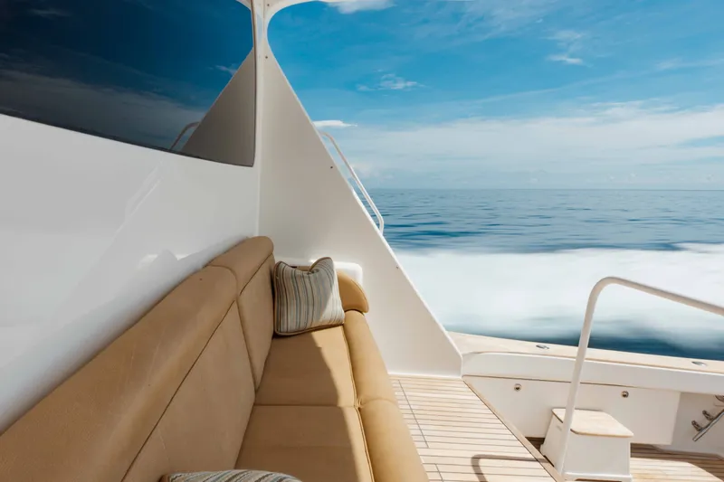 Slide: The Image of Luxurious seating on 2012 Viking 76 Enclosed Bridge yacht, cruising on calm ocean waters. - 31