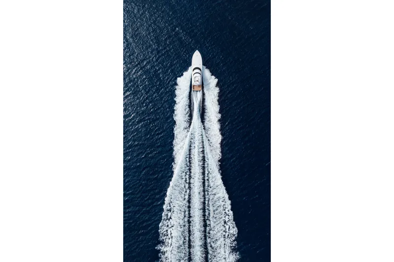 Slide: The Image of Aerial view of 2012 Viking 76 Enclosed Bridge yacht cruising on open water. - 13