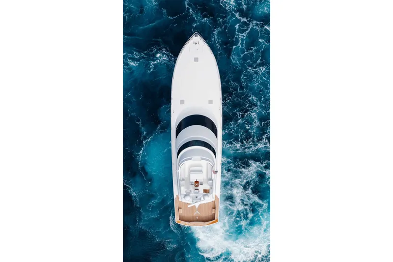 Slide: The Image of Aerial view of 2012 Viking 76 Enclosed Bridge yacht cruising in blue ocean waters. - 16