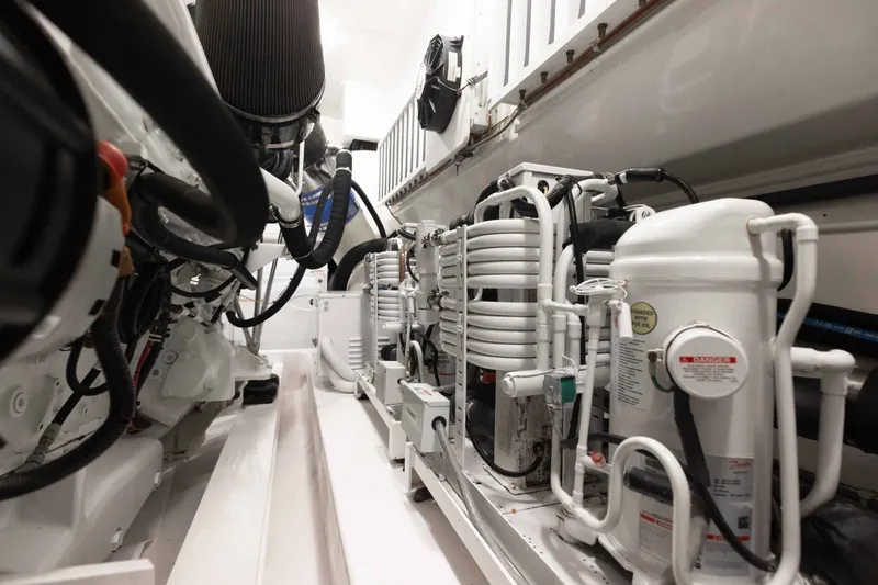 Slide: The Image of Engine room of 2012 Viking 76 Enclosed Bridge yacht, showcasing mechanical components. - 111