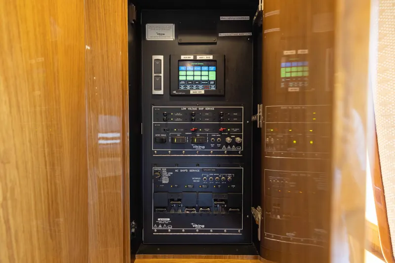 Slide: The Image of Control panel inside 2012 Viking 76 Enclosed Bridge yacht, featuring advanced navigation and system controls. - 80