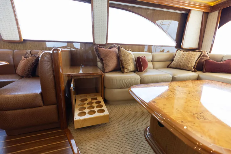Slide: The Image of Luxurious interior of 2012 Viking 76 Enclosed Bridge yacht with plush seating and elegant wood finishes. - 66
