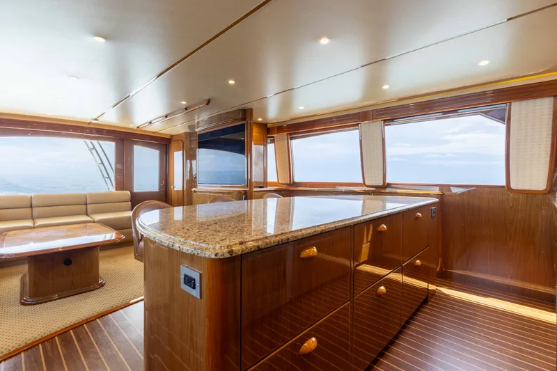 Slide: The Image of Luxurious interior of 2012 Viking 76 Enclosed Bridge yacht with elegant wood finishes and ocean view. - 72