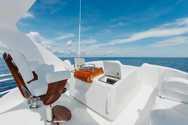 Slide: The Image of Luxurious 2012 Viking 76 Enclosed Bridge yacht helm with ocean view and clear skies. - 43