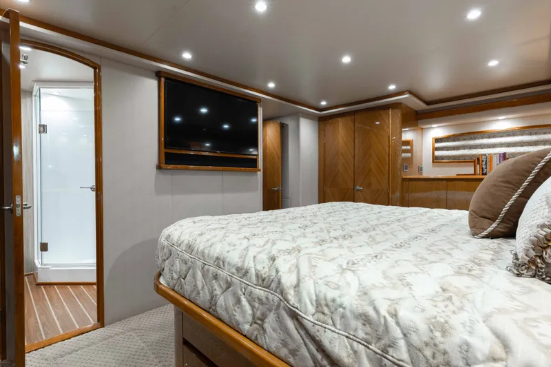 Slide: The Image of Luxurious bedroom interior of 2012 Viking 76 Enclosed Bridge yacht with elegant wood finishes. - 86